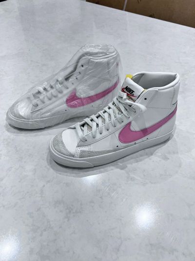 nike white high-top sneakers with pink swoosh