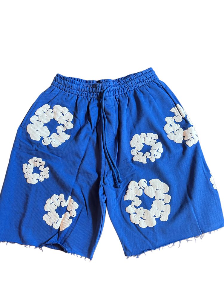 denim tears blue shorts with white floral patterns