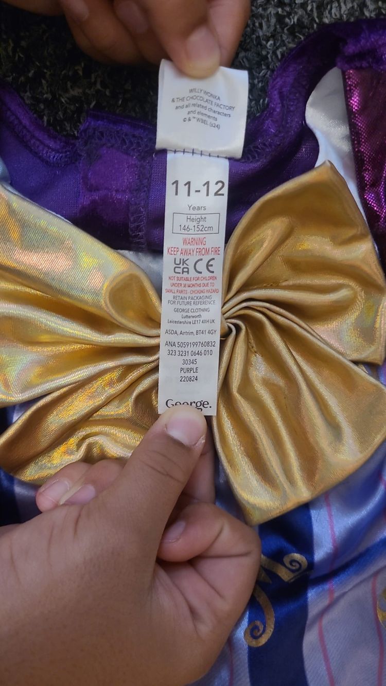 purple and gold children's costume jacket with bow