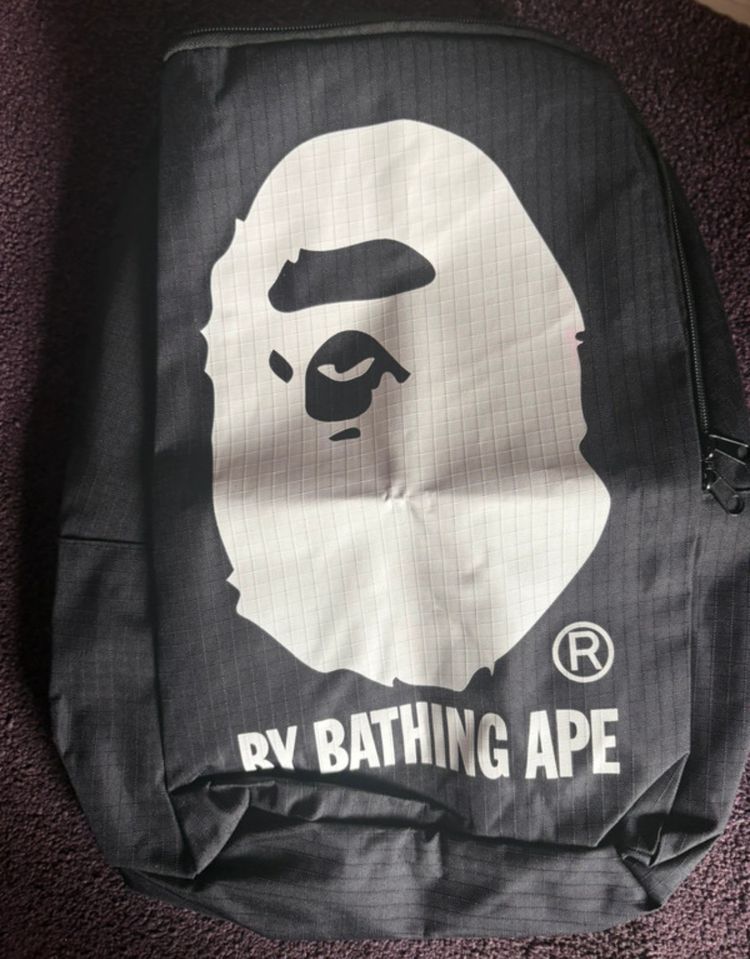 Black Backpack With White Ape Face Logo And Text image 1