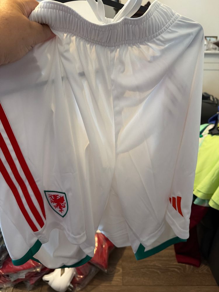 White Sports Shorts With Red Stripes And Wales Emblem
