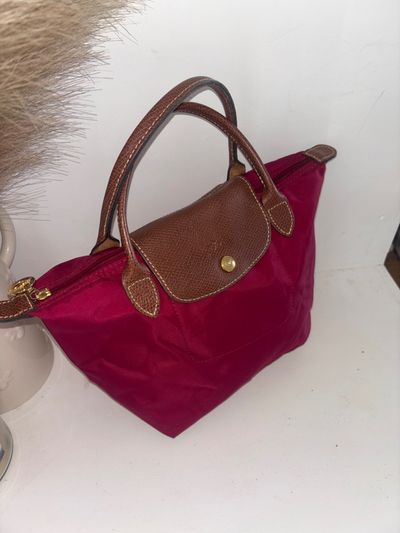 Pink Handbag With Brown Leather Handles And Flap