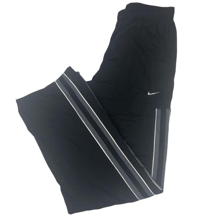 Nike 2000s Nike Tracksuit Bottoms on a grey tag, this pair features stripes down the side of both legs wi product image