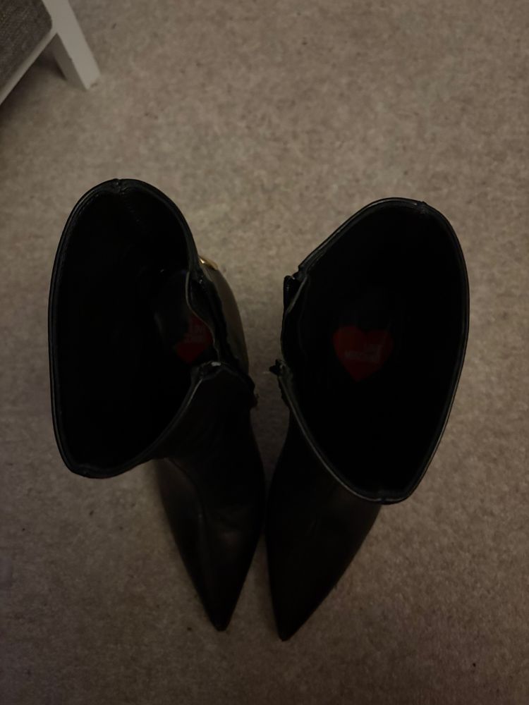 Black pointed toe stiletto ankle boots with gold heart detail