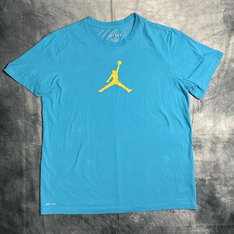 Nike blue Jordan T-shirt with a  yellow Jumpman logo detailing in the centre of the T-shirt, also in image 1