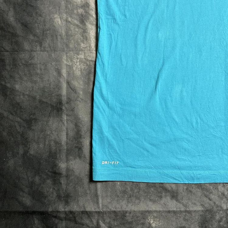 Nike blue Jordan T-shirt with a  yellow Jumpman logo detailing in the centre of the T-shirt, also in image 3