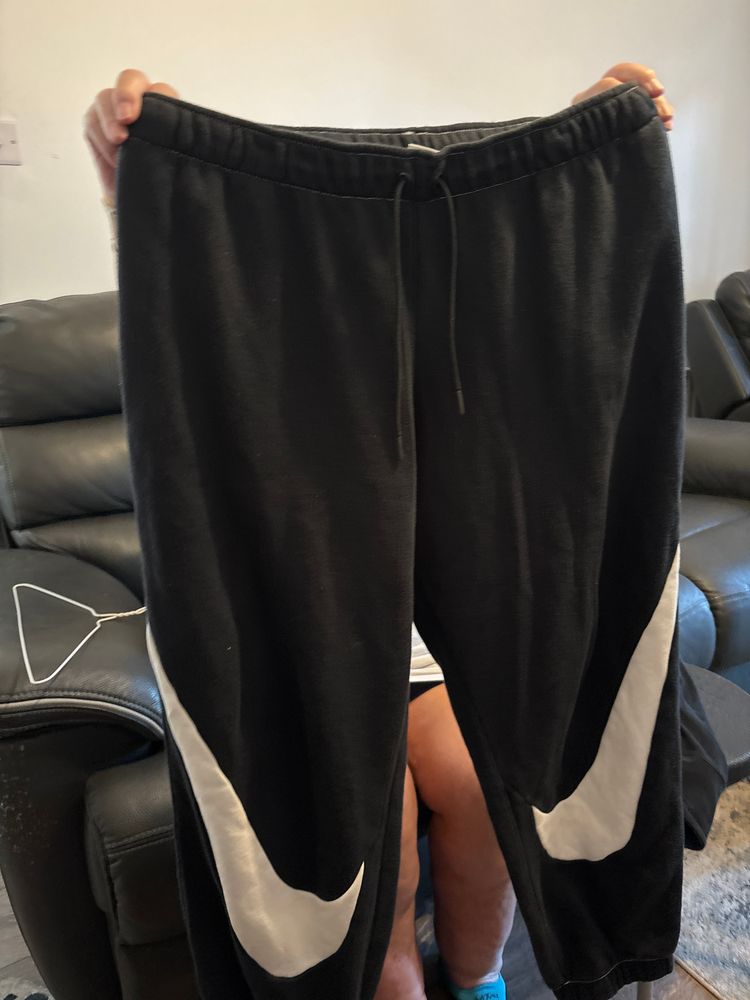 Black Sweatpants With White Swoosh Design