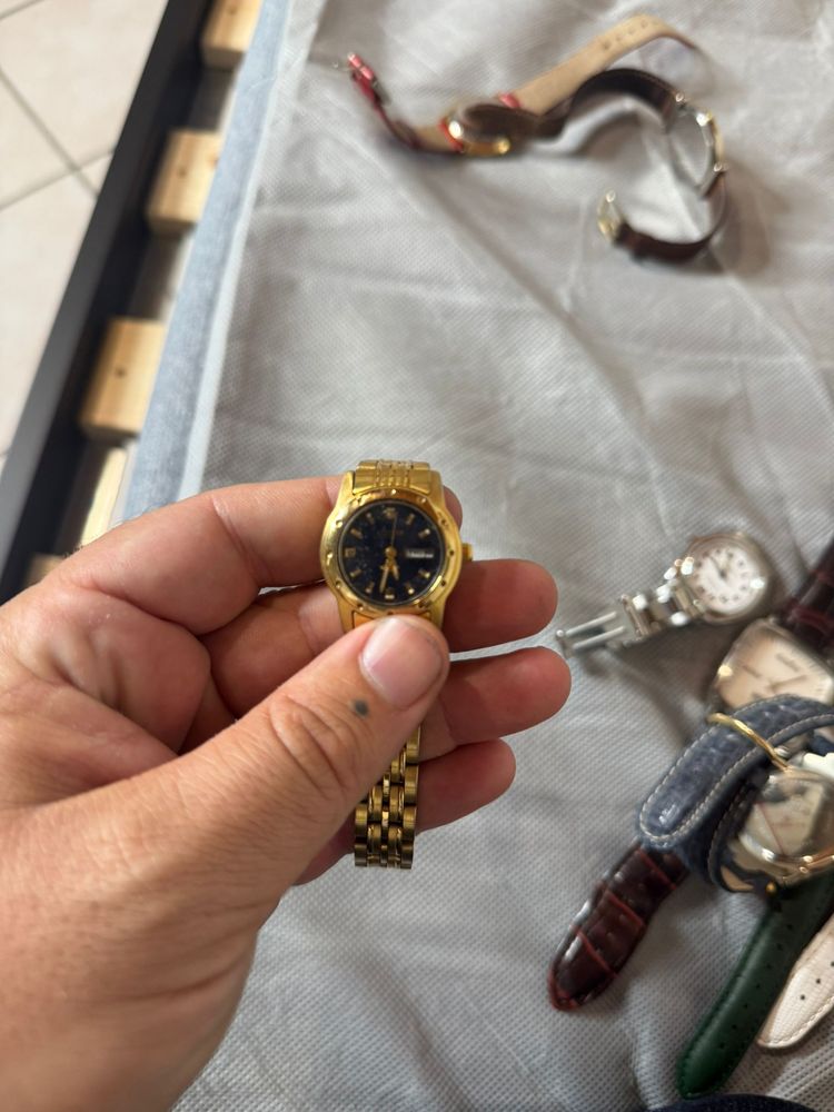 gold wristwatch with black dial