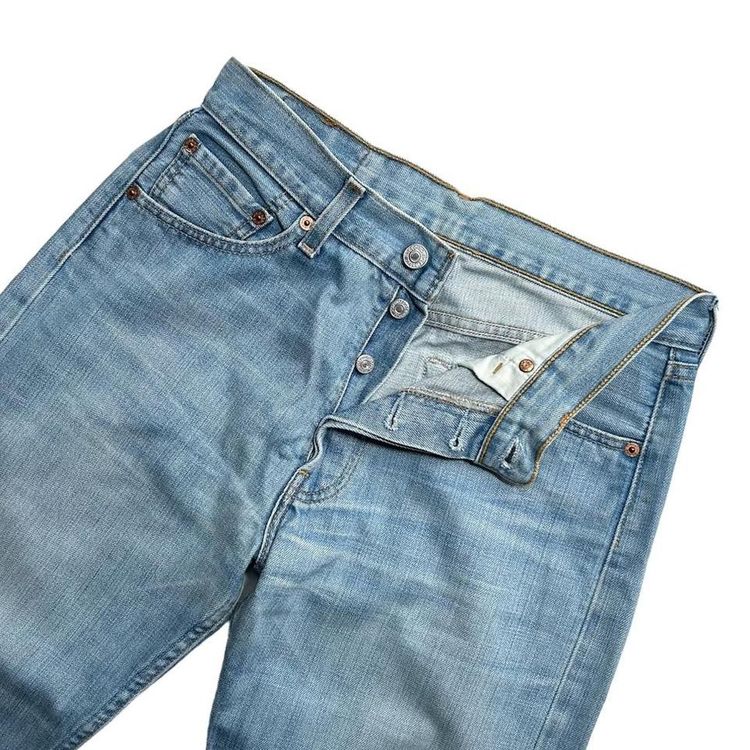 Light wash straight leg button fly Levi 501 jeans made from a stiff denim image 3