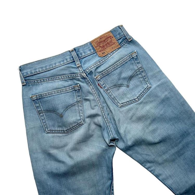 Light wash straight leg button fly Levi 501 jeans made from a stiff denim image 4
