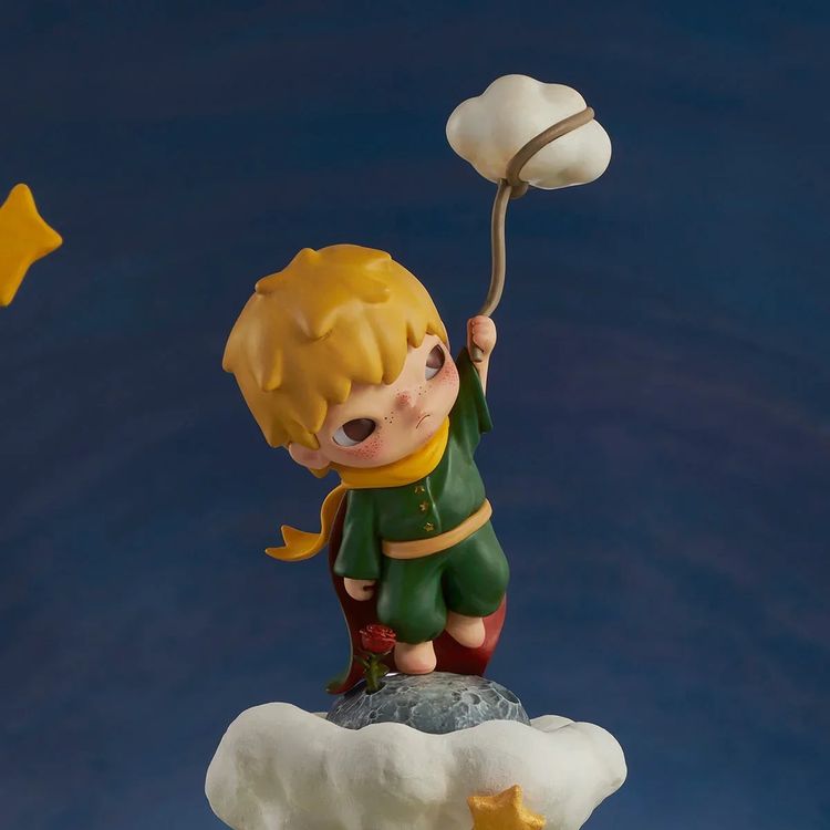 Figurine Of A Boy Holding A Cloud Balloon