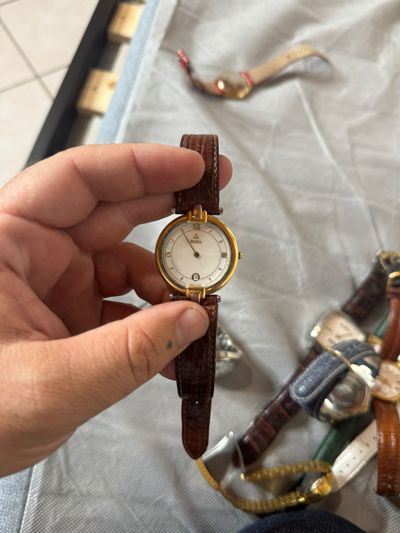 gold-tone wristwatch with brown leather strap