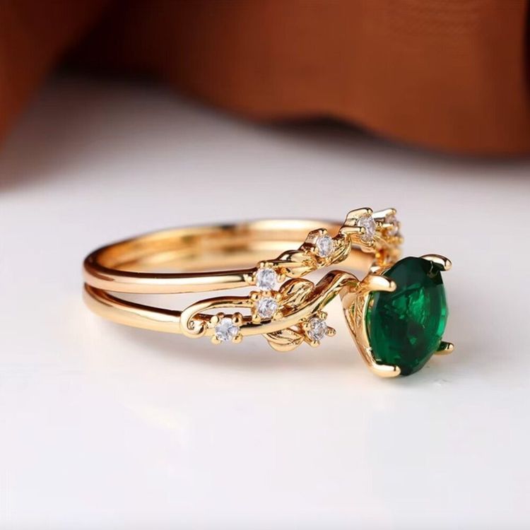 Gold Ring With Green Gemstone And Small Clear Stones