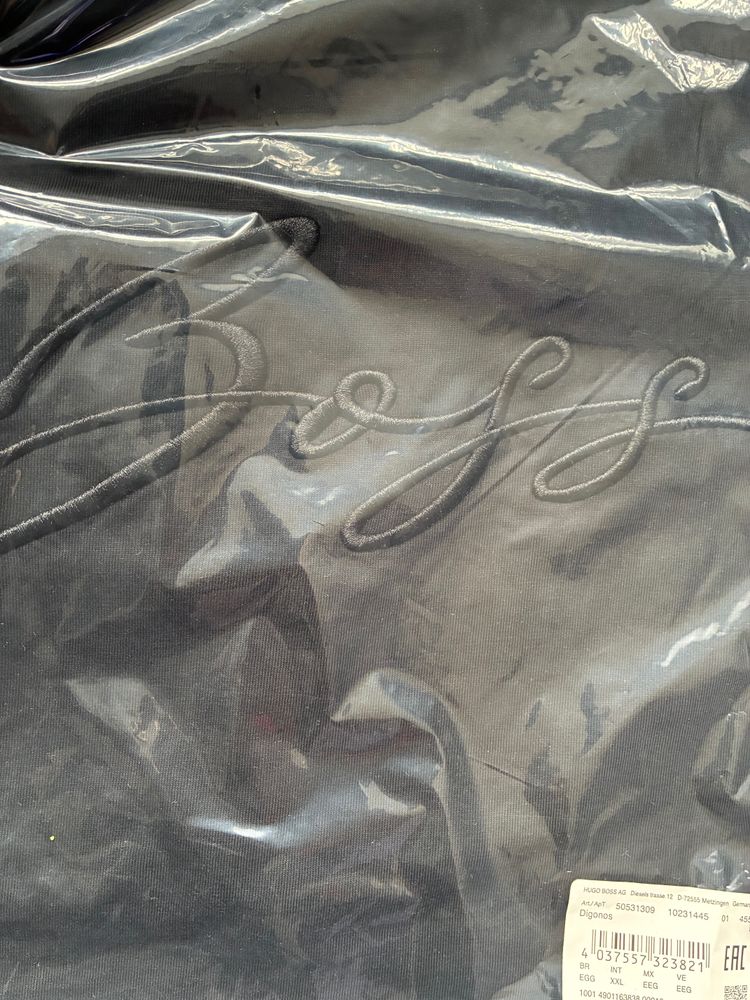 Black Garment With Embossed Cursive Text