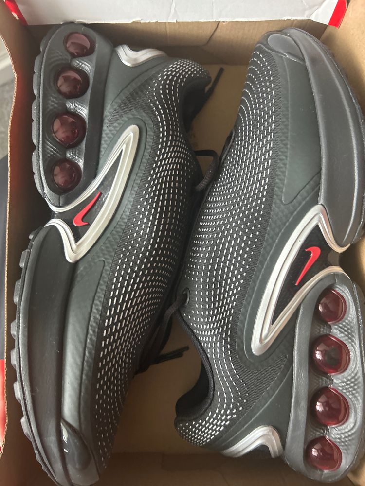 Black And Grey Athletic Shoes With Red Accents
