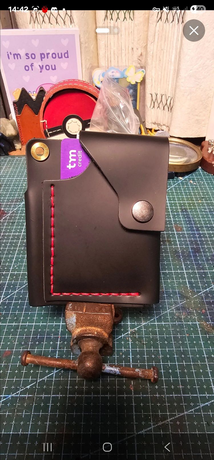 black leather wallet with red stitching