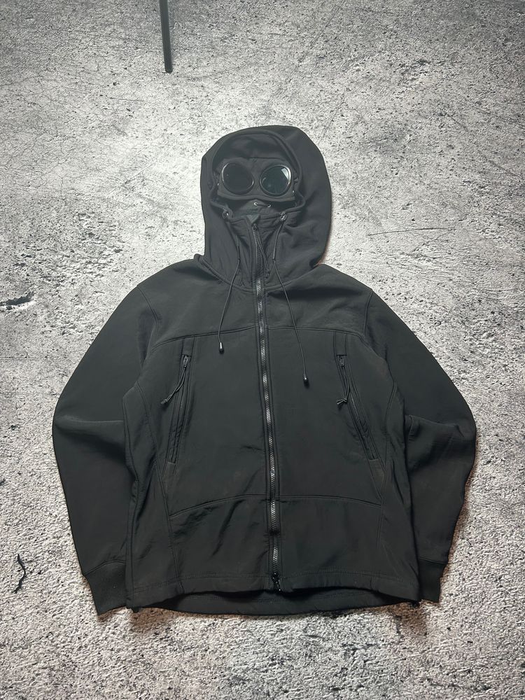 Black Hooded Cp Company Jacket With Goggles On Hood