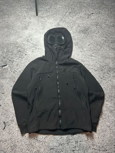 Black Hooded Cp Company Jacket With Goggles On Hood