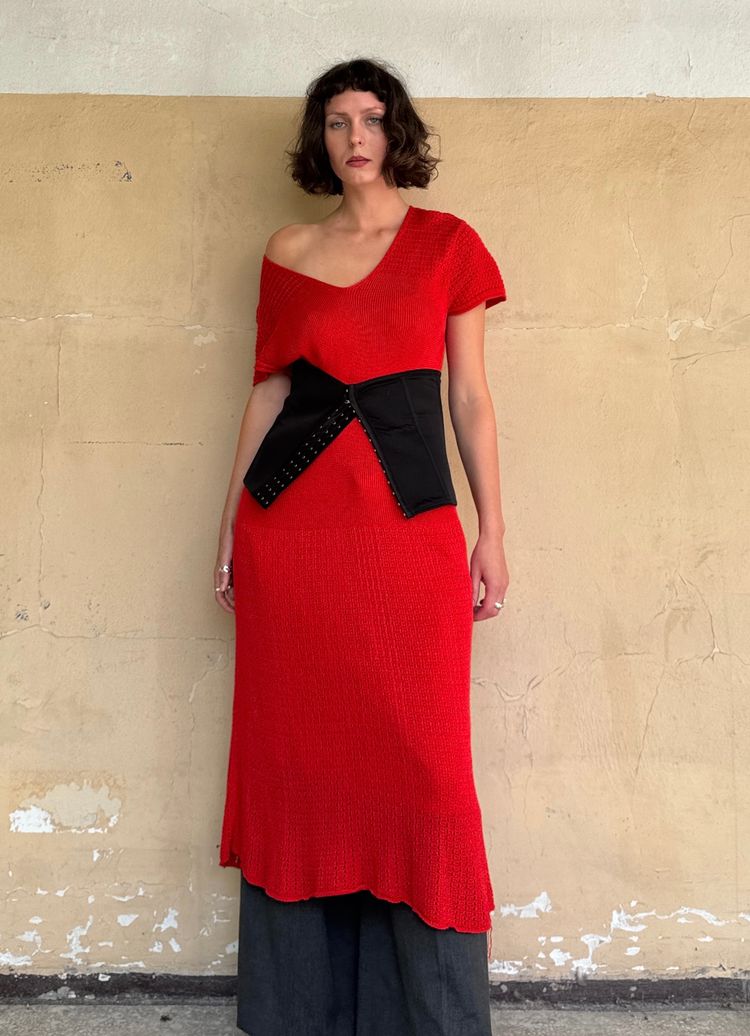 Immagine di red asymmetrical knit dress with black corset belt and gray wide-leg pants 2