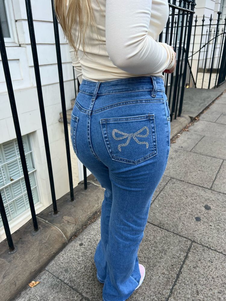blue straight leg jeans with rhinestone bow detail on pocket