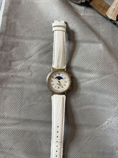 white wristwatch with moon phase dial