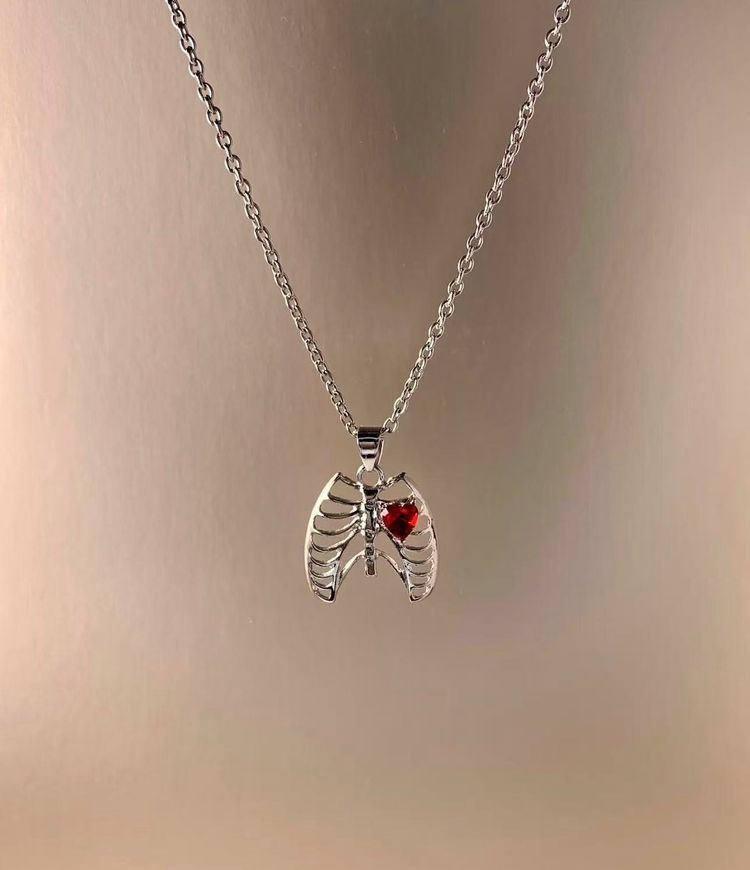 Silver Necklace With Rib Cage Pendant And Red Heart