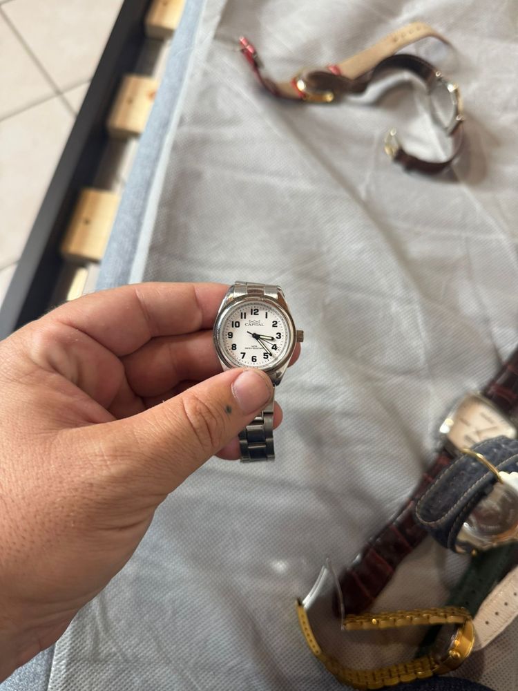 silver wristwatch with white dial