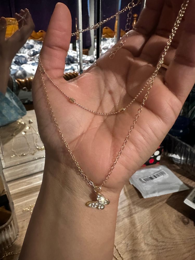 Set Of Gold-Tone Layered Necklaces With Heart, Butterfly, And Pearl Details 3
