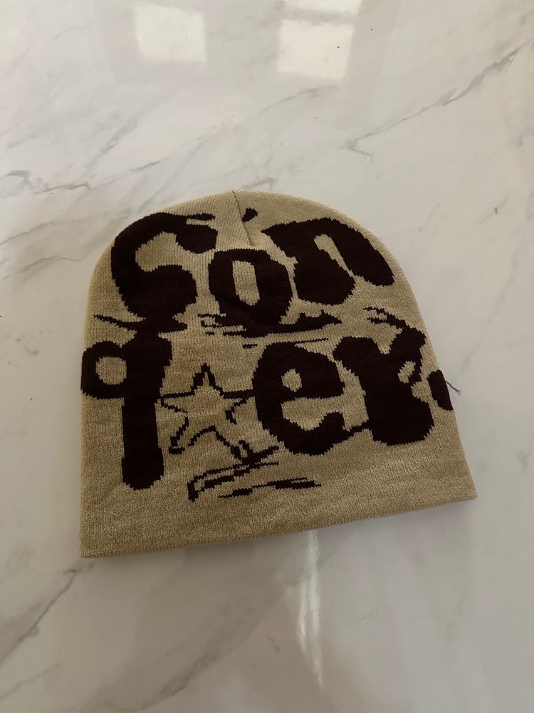 Beige Knit Beanie With Brown Text Design