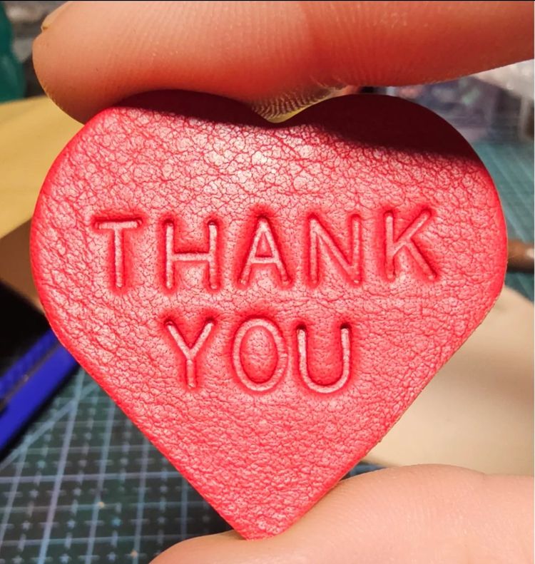 red heart-shaped leather keychain with THANK YOU embossing