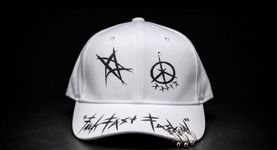 White Baseball Cap With Black Graphic Designs And Metal Rings