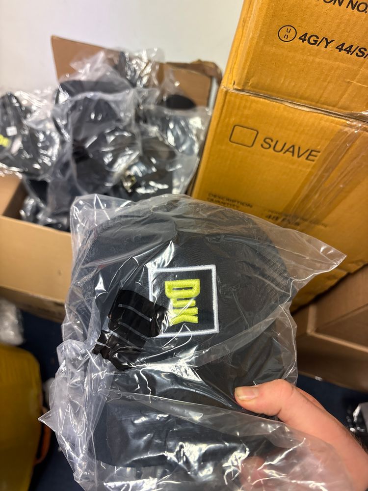 Djk cap with white box with green bold writing 