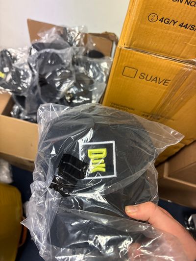 Djk cap with white box with green bold writing