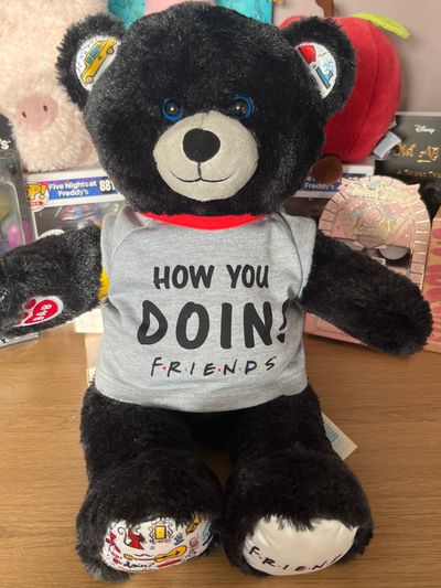 Build and bear Friends Black Teddy Bear With Grey Shirt